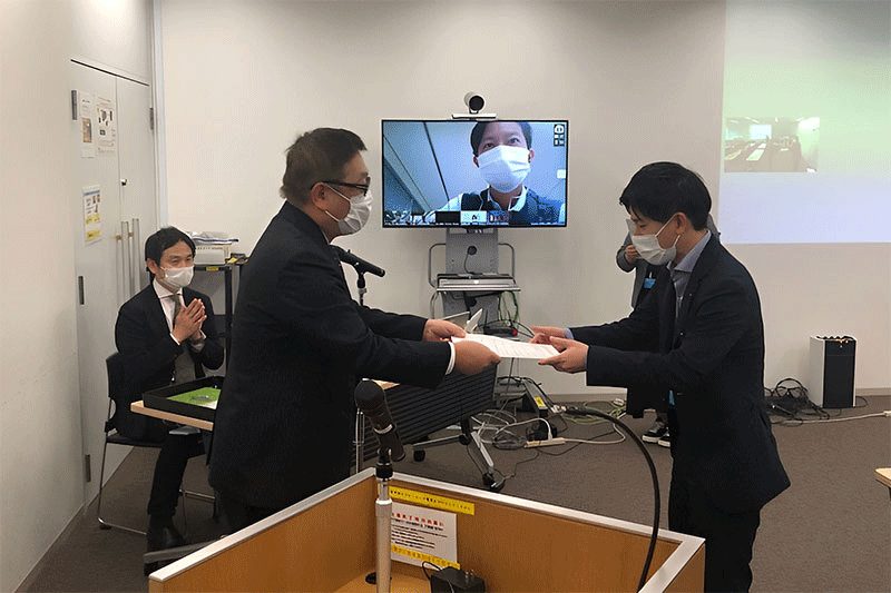 An employee receives his certification at the Ambassador certification ceremony. After completing the training, employees need to pass a test to receive their certification.