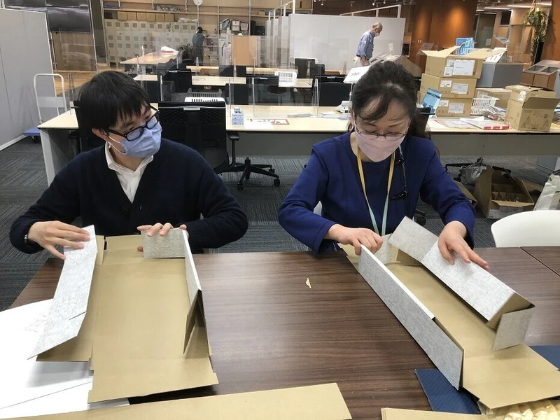 Assembling wine boxes together at an event